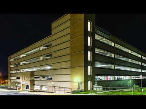 Reston Hospital Center’s parking structure from outside at night, shining brightly with LED parking garage lighting.