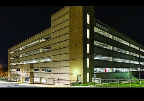 Reston Hospital Center’s parking structure from outside at night, shining brightly with LED parking garage lighting.
