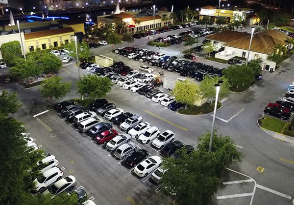 An aerial view of the outdoor LED lighting at The Palms Town Country building and parking lot at night