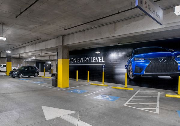 American Airlines Center parking structure in Dallas, TX with bright, high quality lighting from parking garage LED light fixtures in the handicap section.