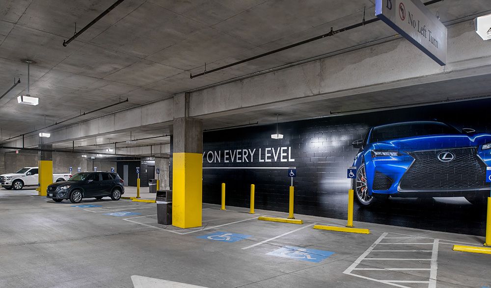 American Airlines Center parking structure in Dallas, TX with bright, high quality lighting from parking garage LED light fixtures in the handicap section.