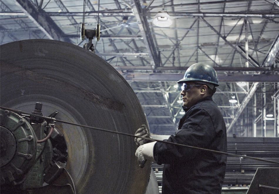 man working in a factory with high-bay lighting